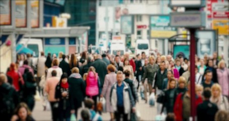 Crowd of People / Commuters Walking / Busy Street. Crowd on a busy street. People walk down a busy street with advertising, billboards, cars and public transport. Slow motion.