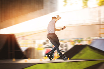 Man is rollerblading. Slalom cones and rollerblader. Improve your balance.