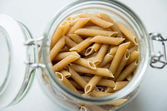 penne pasta in glass jar