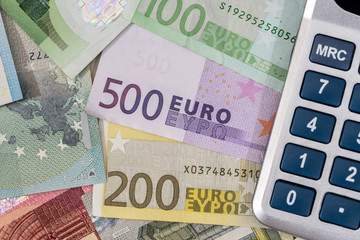 calculator above euro banknotes.