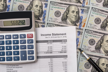 Financial documents with us dollar, pen and calculator
