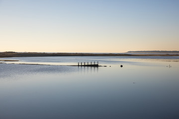 dusk on lagoon  with reflection in still water at nature reserve Casse de la Belle Henriette after sea went over the dike after the storm Xynthia in February 2010