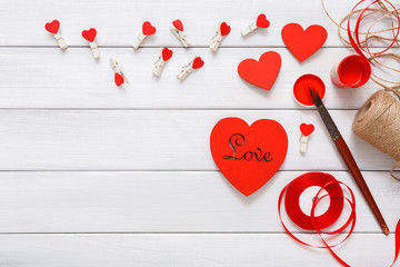 Fototapeta premium Valentine day diy handmade hearts making, top view on wood