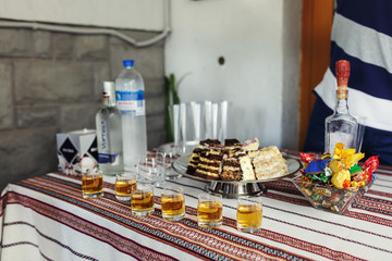 Traditional wedding reception table with alcohol and dessert closeup