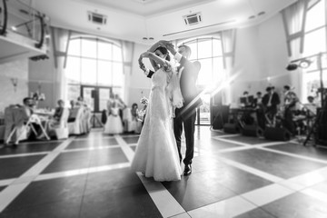 Romantic couple of newlyweds first dance at wedding reception