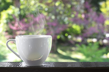 coffee or tea in white cup with smoke or steam heat place on the
