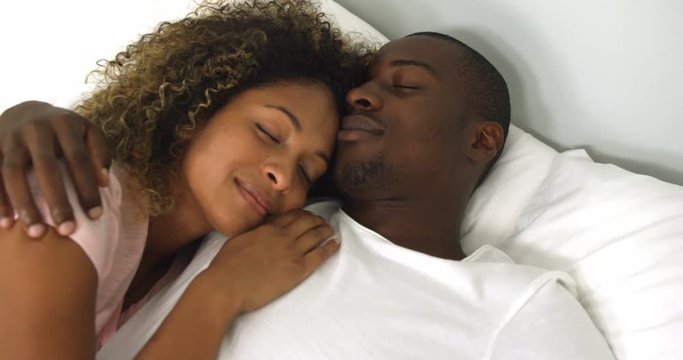 Young couple sleeping together on bed in bedroom 4k
