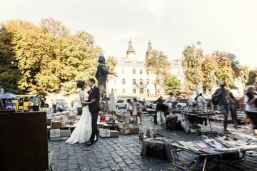 Newlyweds hug among old books' market