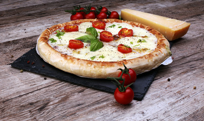 Hot true PEPPERONI ITALIAN PIZZA with salami and cheese. TOP VIEW Tasty traditional pepperoni pizza on board on wooden table with decoration