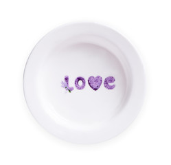 Plate with love text and heart isolated on white background