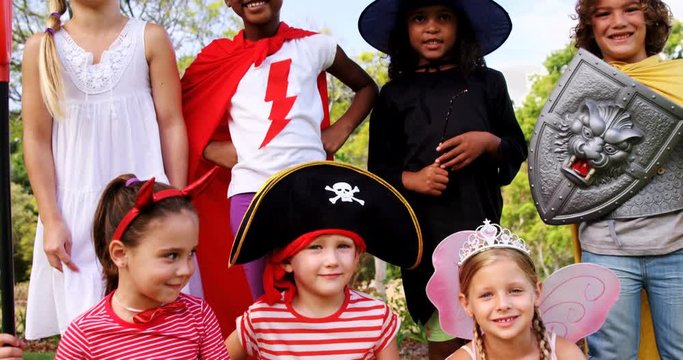 Portrait of group of kids in various costumes in the park 4k