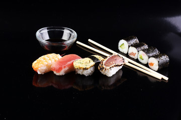 close up of sashimi sushi set with chopsticks and soy - sushi roll with salmon and sushi roll with smoked eel, selective focus.