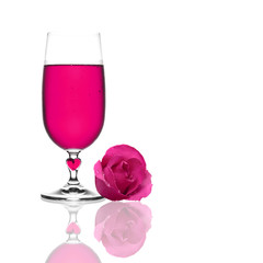 pink wine chilled in clear glass and heart with pink rose petal