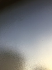 Window glass with cold foggy condensation abstract background, closeup picture