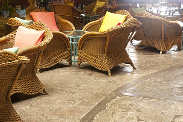 rattan chair with backrest pillow and glass table in reception h