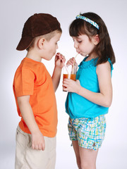 little boy and girl drinking juice