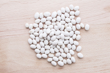 Fototapeta na wymiar white beans on wooden background