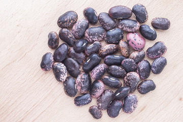 brown beans on wooden background