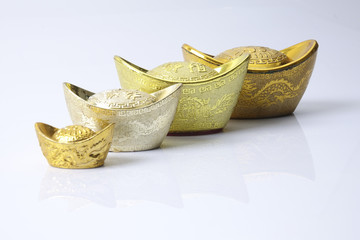 Chinese new year festival decorations,   gold ingots isolated on white. Chinese characters means...