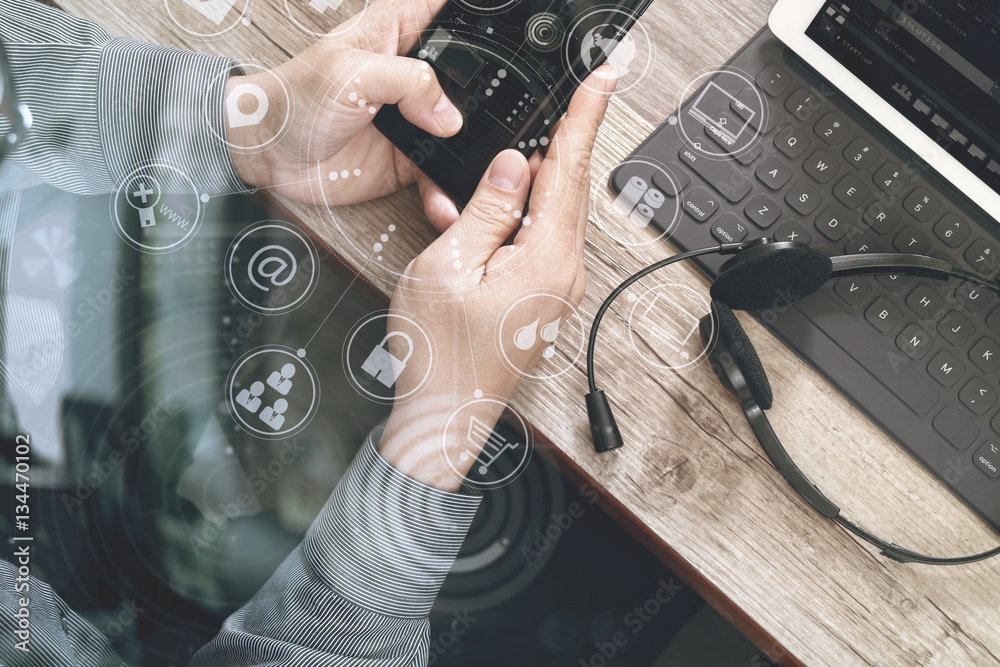 Poster top view of man hand using VOIP headset with digital tablet comp