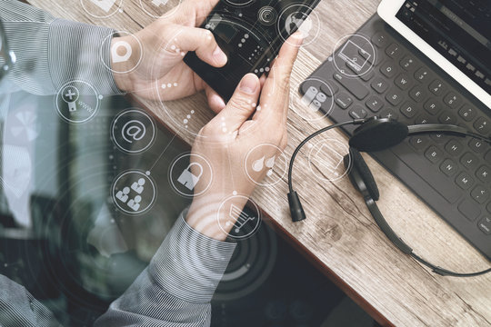 top view of man hand using VOIP headset with digital tablet comp