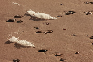 Patterns of sand and stones on the beach in the Black Sea