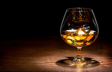 whiskey with ice on a wooden table