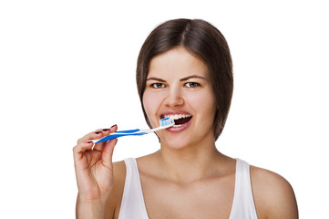 Smiling young woman with healthy teeth holding a tooth brush