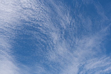 Beautiful pattern of white cirrus clouds in blue sky.