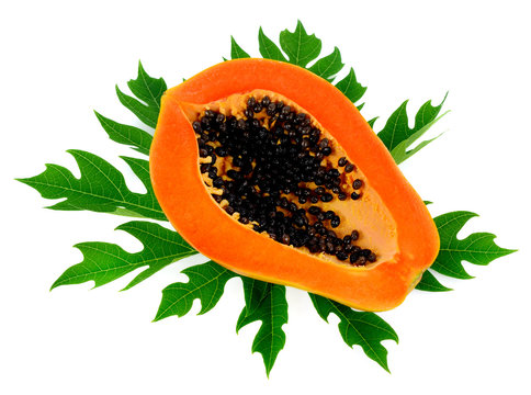 papaya slice on papays leaf isolated on white background