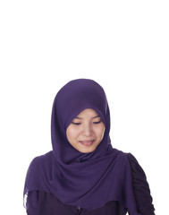 Young muslimah woman smile while looking down