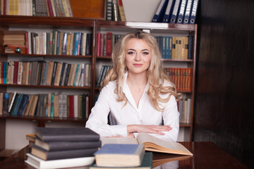 teacher looking at page interesting book in library