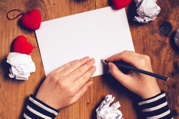 Woman writing love letter for Valentines day - obrazy, fototapety, plakaty