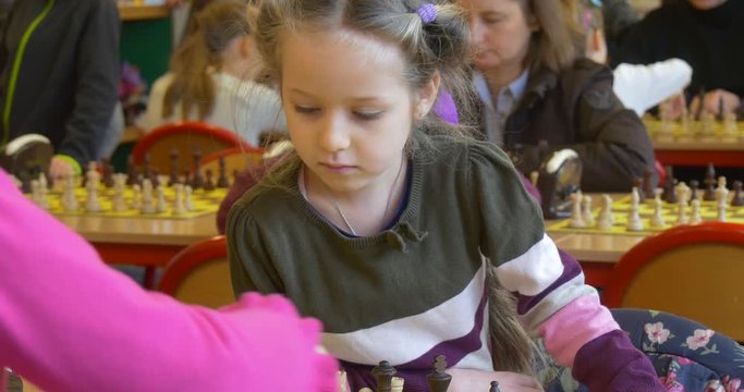 Preschool Girls Playing at Polish Chess Competions Organized by "black Knight" Chess Club and Looking Attentively at Their Chessboard