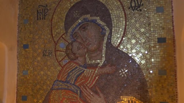 Old Saint Mary Icon Made of Golden Looking Mosaic With Lit Traditional Candles in Chalk Cave in Sviatogorskaya Orthodox Lavra