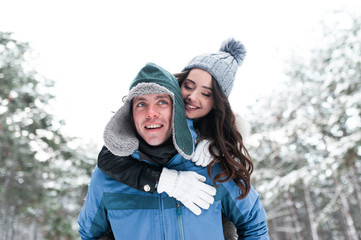 Outdoor portrait of cheerful handsome bearded man and pretty girl