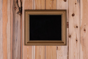 blank vintage gold frame on the old wooden background