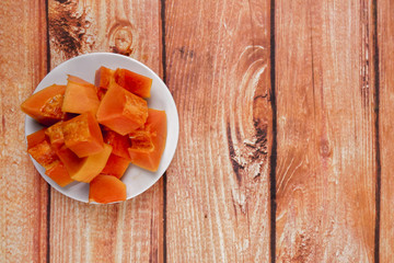 sliced of papaya on wooden background.