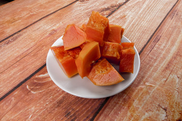 sliced of papaya on wooden background.