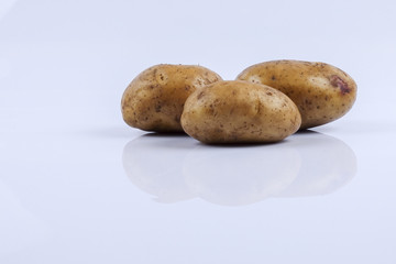 Fresh raw potato on white background.