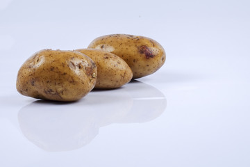 Fresh raw potato on white background.