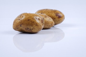 Fresh raw potato on white background.