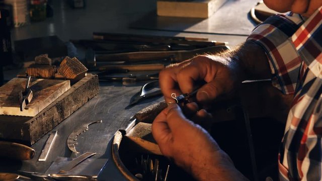 Close-up of goldsmith working in workshop 4k