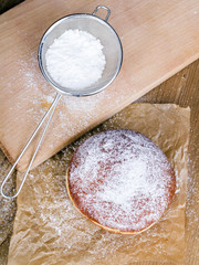 donuts with powdered sugar on a wooden table