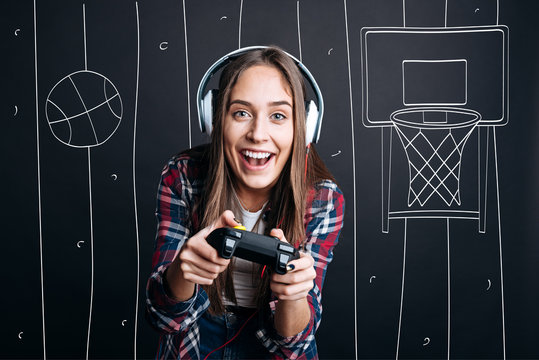 Overjoyed delighted woman plauing video games