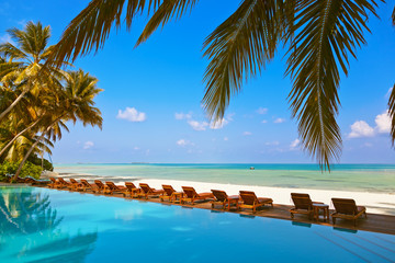 Loungers and pool on Maldives beach