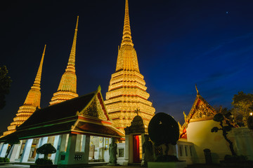 Fototapeta premium Thai Pagoda art architecture with sunset in Wat Phra Chetupon Vimolmangklararm (Wat Pho) temple, Thailand.