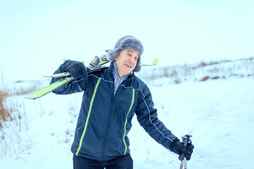 Fototapeta na wymiar senior at the cross-country skiing in winter