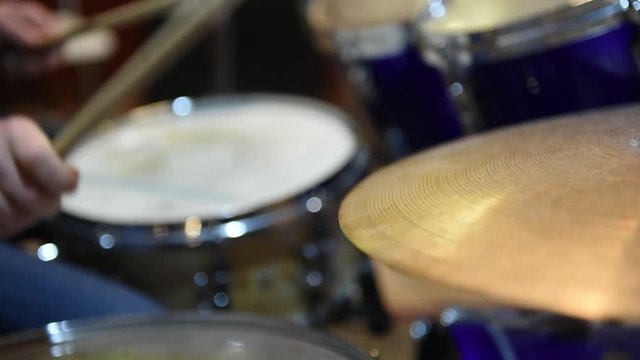 Drummer playing instrument. Closeup on cymbal movement