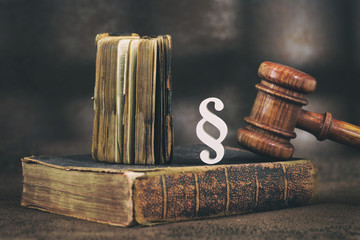 Law gavel on old brown leather book 